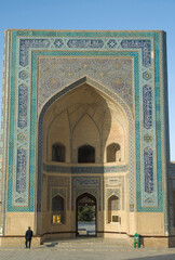 Impressive entrance (Iwan, Pishtaq)  of Kalyan Mosque part of Po-i-Kalyan Complex with  arch and decoration of ceramic mosaic, calligrahy, and geometric ornaments in Bukhara , Uzbekistan, Asia