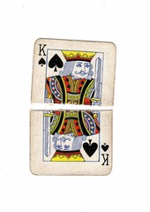 A vintage playing card torn in half on a white background.