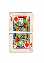 A vintage playing card torn in half on a white background.