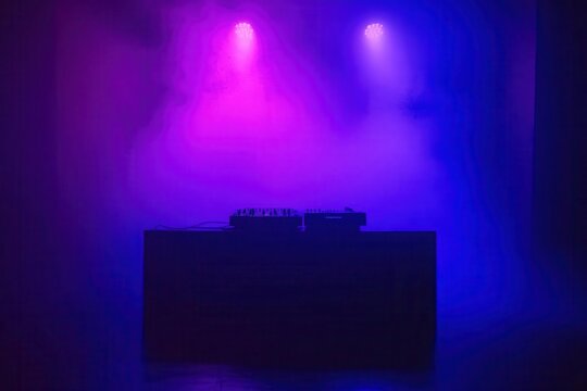 atmospheric nightclub dj setup with dramatic purple and blue lighting turntable silhouette against a smoky background