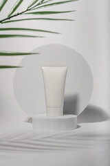 white cosmetic packaging with palm leaf 