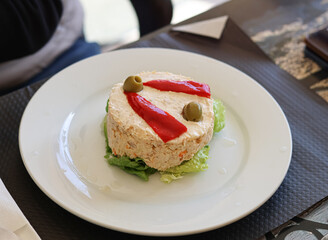 Russian salad with pepper and olives.