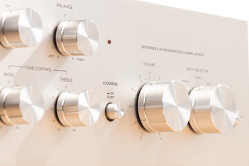 Close-Up of Audio Equipment Control Panel with Metal Knobs and Labels