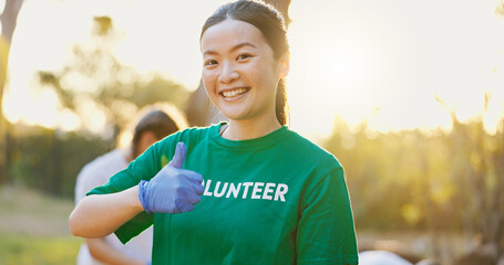 Portrait, volunteer and happy woman with thumbs up outdoor for community service, success or yes. Hand gesture, charity worker and person at park with like emoji, thank you and ngo goal at sunset