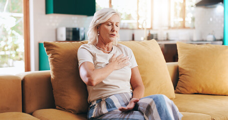 Home, heart attack and senior woman on sofa, chest pain and cardiac arrest in living room....