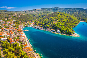 Obraz premium A breathtaking aerial view of Povlja on Brac Island, Croatia, showcasing its beautiful Adriatic coastline, crystal-clear waters, and charming Mediterranean village, making it a perfect summer retreat