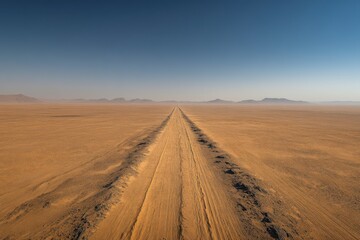 Fototapeta premium Photo of the Sahara Desert with car tracks stretching across the sand dunes as far as the eye can see.