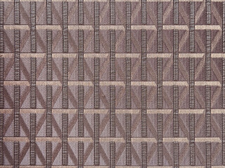 Close up of purple maroon fabric in random geometric diamond and lines pattern. Brown maroon color...