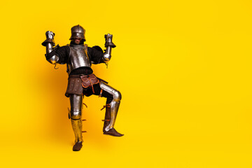 Naklejka premium Dynamic knight in shining armor posing energetically against a vibrant yellow background
