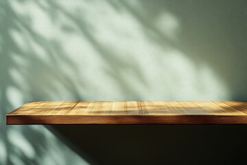 Wooden shelf, sunlight shadows, green wall, product display