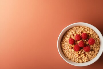 Bowl of granola topped with fresh raspberries against warm backg