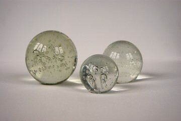 Clear glass balls on a white table 
