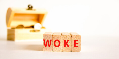 Woke question symbol. Concept word Woke question on beautiful wooden blocks. Chest with coins....