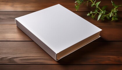 Fototapeta premium A hardcover book mockup on a wooden table featuring a minimalist cover design placeholder—perfect for showcasing book covers, branding, or editorial design concepts with a clean aesthetic. 