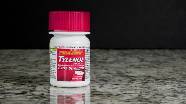 NORWALK, CT, USA- FEBRUARY 19, 2025: A bottle of extra strength pain relief medication Tylenol is placed on a granite countertop in a kitchen setting. The label specifies adult use and contains inform
