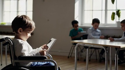 Preschool student using digital tablet in wheelchair, demonstrating educational accessibility and technological support within inclusive classroom environment - Powered by Adobe