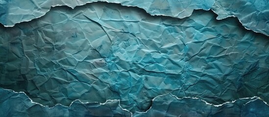 Fototapeta premium Torn paper frame on blue background with textured surface and copy space for text