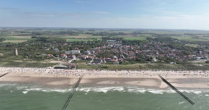 Domburg, Zeeland beach full of people swimming, sun batching, recreation in summer time. Touristic recreation.