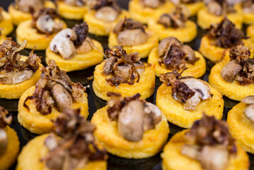 Golden polenta bites topped with savory sautéed mushrooms Perfect appetizer for any party Delicious!