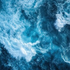 Fototapeta premium Aerial View of Deep Blue Ocean Water with White Foamy Waves Creating a Dynamic and Abstract Pattern Nature Beauty