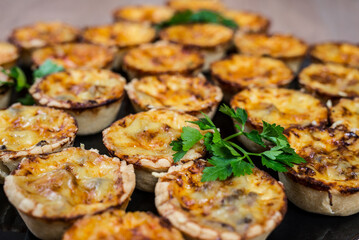 Assortment of savory mini tarts These tarts have a variety of toppings and are bite sized treats
