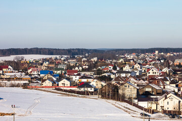 winter photography of a snowy suburban neighborhood, showcasing snow-covered houses and trees in a peaceful setting, perfect for seasonal marketing and landscape visuals.
