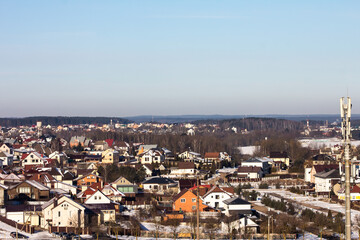 winter photography of a snowy suburban neighborhood, showcasing snow-covered houses and trees in a peaceful setting, perfect for seasonal marketing and landscape visuals.