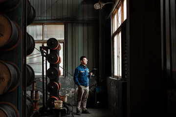 Asian men are using digital tablet in a textile factory.
