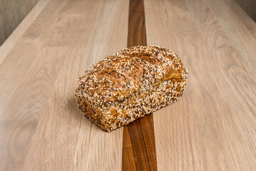 Whole grain bread loaf with seeds on a wooden surface healthy and freshly baked nutrition Delicious...