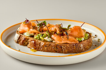 Gourmet Salmon and Avocado Bruschetta on Artisan Bread with Warm Lighting and Natural Composition