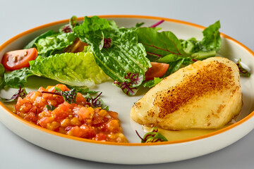 Gourmet Presentation of Grilled Halami with Fresh Vegetable Salsa on Elegant Plate