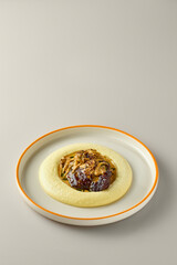 Elegant Culinary Presentation of Pork Cheeks with Velvet Mashed Potatoes and Rich Mushroom Sauce