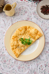 Golden Cheburek on Plate Rustic Culinary Delight with Warm Colors and Textured Details