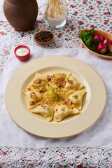 Elegant Presentation of Dumplings with Potatoes and Bacon on a Decorative Table Setting
