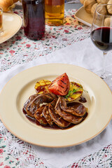 Gourmet Presentation of Tongue in Demi-Glace Sauce with Fire-Roasted Potatoes and Baked Tomato