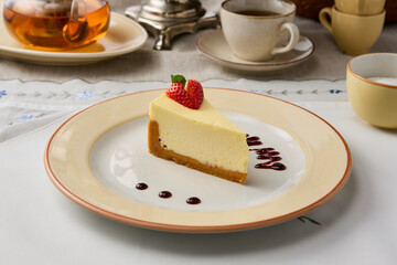 Elegant Presentation of Classic Cheesecake Slice with Warm, Cozy Ambiance