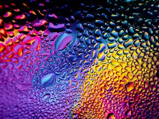 Close-up of water drops on metal surface in high resolution showing condensation of water droplets on metal surface. Intricate patterns and different sized water droplets create a beautiful abstract