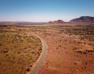aerial drone view of desert road and mountains  in Karijini, Western Australia © Diana