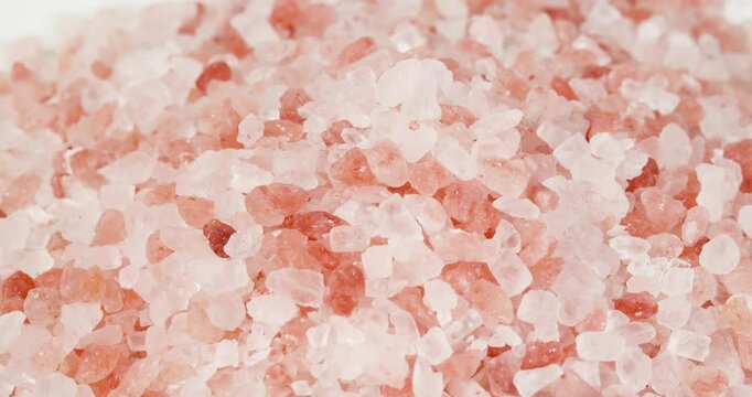 Himalayan Salt, Pink Himalayan Salt Crystals Close up. Pink Coarse Salt Crystals Macro Shot, Rotating Pink Background, Slow Motion Video