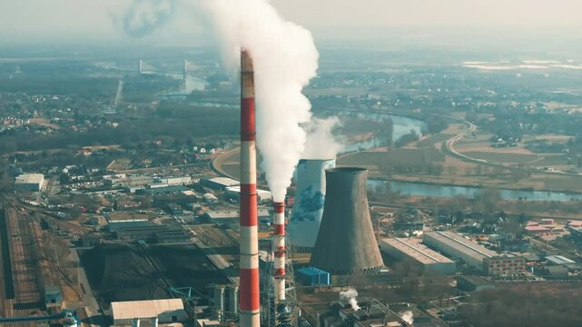 Coal power plant emits significant air pollution in industrial area near river