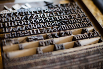 Close-up of vintage letterpress type blocks in a wooden case