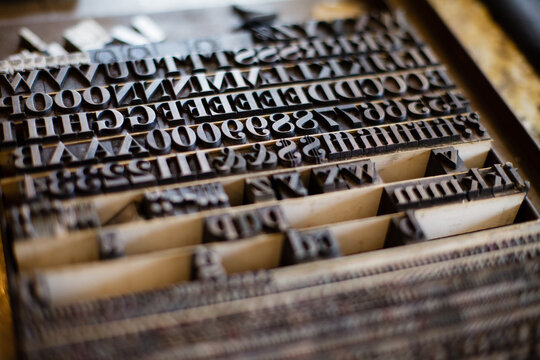 Close-up of vintage letterpress type blocks in a wooden case