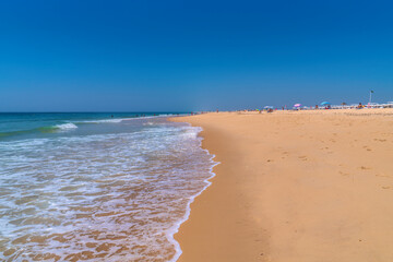 Tavira Island beach south of the town of Tavira Portugal the Algarve with beautiful blue sea and sky