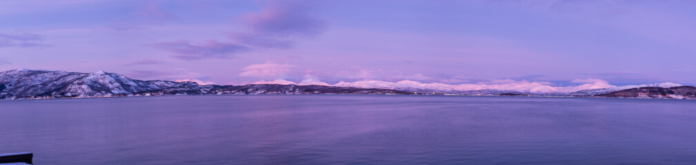 panoramic view of snow mountain and vast sea with pink color during polar night,  Brøstad, Norway