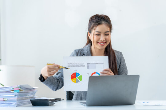 Successful Presentation: An elegant Asian businesswoman is engrossed in a dynamic video conference call.