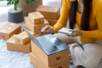 E-commerce Startup: An entrepreneur, surrounded by shipping boxes, meticulously manages online...