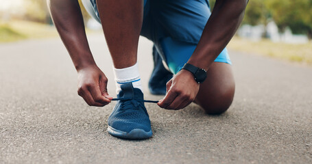Black person, hands or tying laces with shoes on street for fitness, run or workout preparation at outdoor park. Closeup, runner or athlete getting ready with sneaker tie for exercise, sprint or race