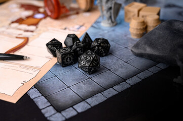Close up of black d20 on character sheet. Board games, RPG, abstract concept of randomness and chance. Dice game, RPG