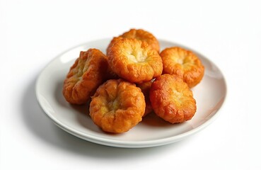 Close-up of golden fried savory fritters served on white plate. Crispy fritters, popular street snack and appetizer. Delicious tasty golden fried food on white background.