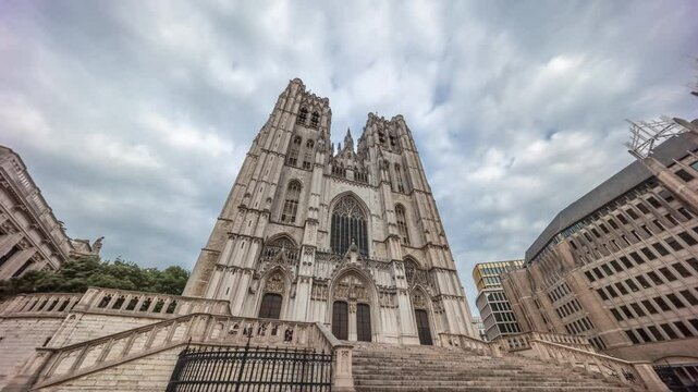 Hyperlapse of the Brussels Cathedral of St. Michael and St. Gudula, Belgium. Gothic spires, intricate carvings and towering facade under a cloudy sky showcase its architectural heritage timelapse